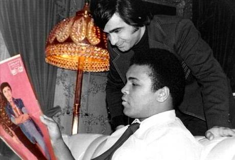 POET & BOXER: Aref with famed Boxer Champ Mohammad Ali looking at a Googoosh centerfold.