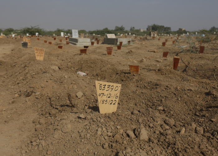 A wooden marker displaying count number, date and serial number, placed on the grave of an unidentified body at the Edhi Foundation graveyard.