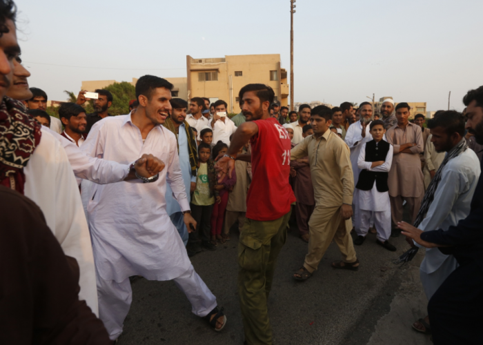 Safdar dances with others at Clifton Beach.